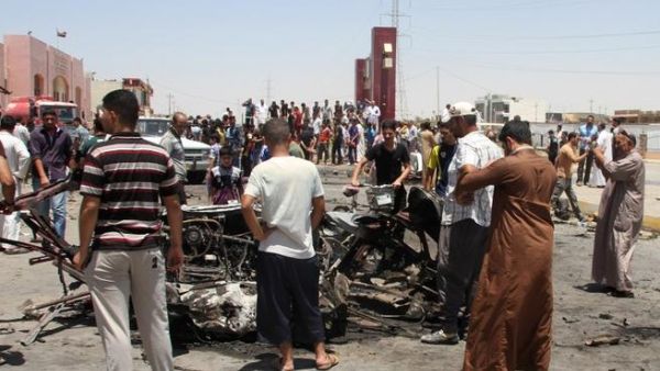 Iraqis inspect the site of a suicide car bomb attack in the Al-Haq square in Samarra, a predominantly Sunni town north of Baghdad, on July 5 (AFP)