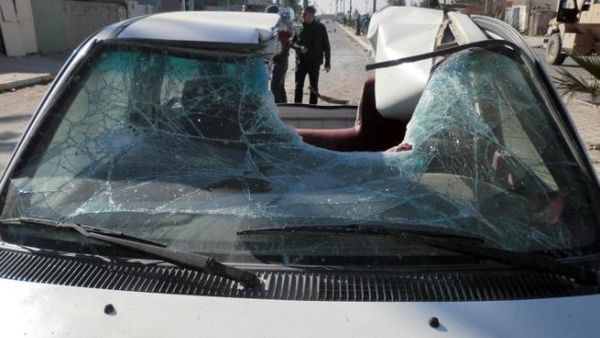 The roof of vehicle is partially destroyed following of a suicide car bomb that detonated outside a central police station in the northern Iraqi city of Kirkuk earlier this month. [AFP]