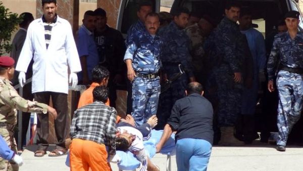 Iraqi medics wheel a man to hospital after demonstrators and security forces near Kirkuk (Marwan Ibrahim/AFP)