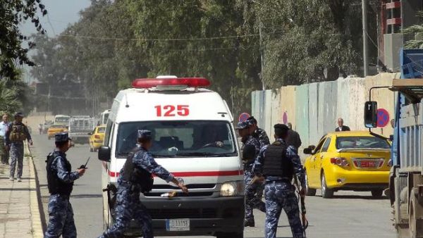 Iraqi soldiers surround an ambulance after deadly clashes at a Sunni protest camp in Hawija, near Kirkuk