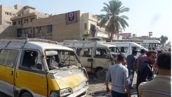 raqis gather following an explosion at a bus station on October 27, 2013, in the the Mashtal district of the capital Baghdad. (Image credit: AFP)