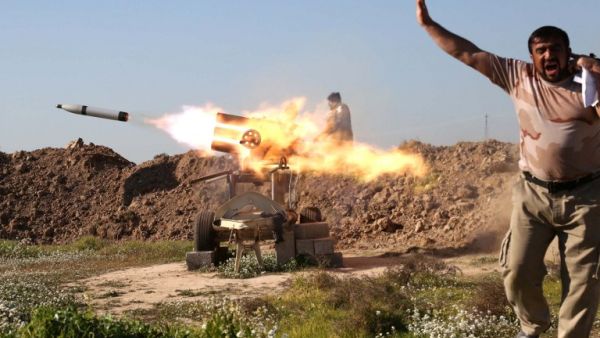 A fighter from the pro-government Popular Mobilization units covers his ears as he sets off a rocket launcher in Taz Khurmatu, outside Kirkuk, as they try to recapture a village from Daesh on February 16, 2016. (AFP/Mohammed Sawaf)