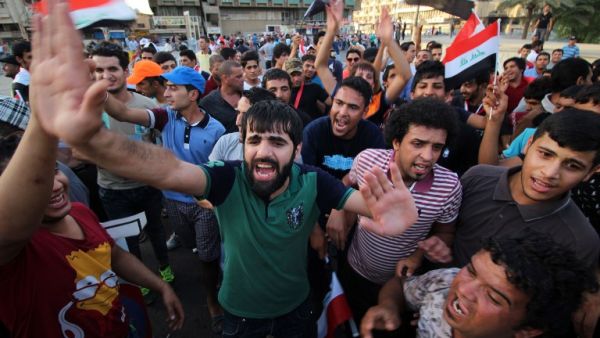 Iraqi protesters shout slogans during a demonstration against corruption in Baghdad's Tahrir Square on Sept. 4, 2015. (AFP/Haidar Mohammed Ali)