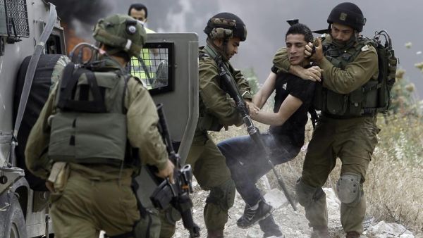 Israeli security troops forcibly detain a young Palestinian during clashes in the West Bank. (AFP/File) Israeli security troops forcibly detain a young Palestinian during clashes in the West Bank. (AFP/File)