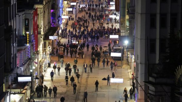 Pedestrians walk down Istiklal Street, a busy shopping and entertainment hub in central Istanbul, on March 20, 2016, a day after a suicide attack. (AFP/Yasin Akgul)