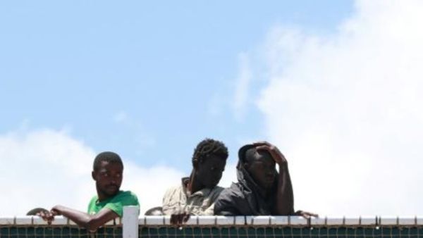 مهاجرون ينتظرون إنزالهم من سفينة دوريات للدرك الإسباني في مرفأ ساليرنو بجنوب غرب إيطاليا

