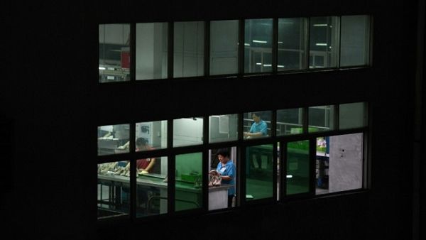 Night-shift workers at the Huajian shoe factory, where about 100,000 pairs of Ivanka Trump-branded shoes are made, in Dongguan, south China. (Greg Baker/ AFP)