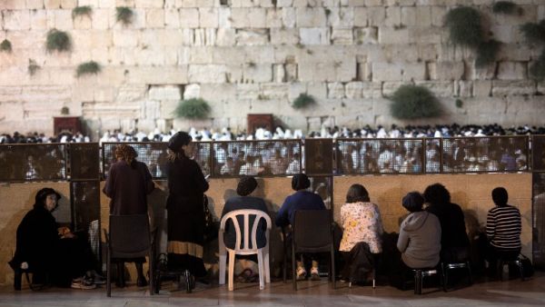 Orthodox Jewish women and men pray during the annual Tisha B'Av (Ninth of Av) fasting and a memorial day, commemorating the destruction of ancient Jerusalem temples some 2,000 years ago, at the Western Wall in Jerusalem's Old City on July 26, 2015. (AFP/Menahem Kahana)