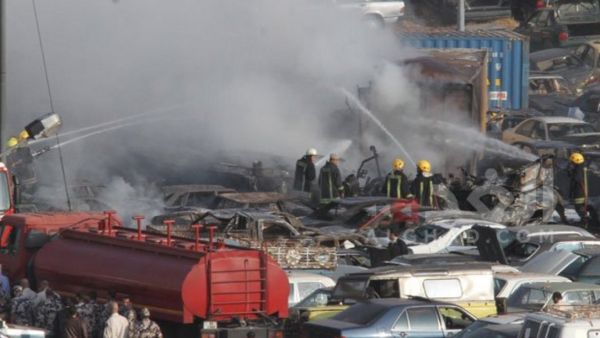 Firefighters extinguish the massive fire in the Customs Department yard in southern Amman that killed five people Monday. (Twitter)