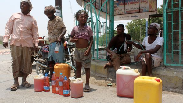 Yemenis sell petrol on the street after Yememi government forces re-entered Zinjibar the capital of the southern Abyan province on August 16, 2016 following an offensive backed by Saudi-led air strikes to recapture the city from Al-Qaeda jihadists. (Photo credit: AFP)