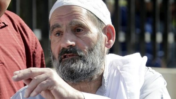 Omar Othman, the father of radical Islamist cleric Abu Qatada, stands outside the state security court in Amman on July 7 (AFP)