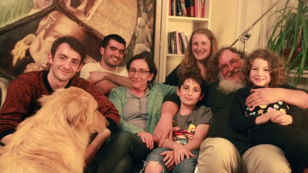 The Jellinek family in their home in Berlin, with their houseguest, Kinan, a Syrian Muslim refugee (second from left). When Chaim Jellinek told Kinan he was Jewish, Kinan said he had no problem with that. (Photo credit: Credit: Daniel Estrin).