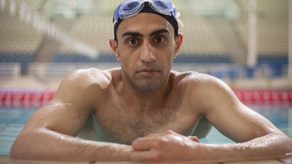 Ibrahim Al-Hussein, a 27-year-old Syrian refugee living in the Greek capital, is taking the Olympic flame through the Eleonas refugee camp as a symbol of solidarity with refugees across the globe. (UNHCR/YORGOS KYVERNITIS)
