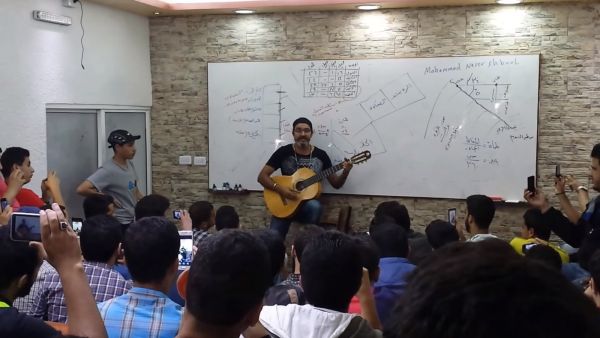 Whether he is dancing, playing Oud or guitar, Shbool is always full of energy while teaching (Youtube)