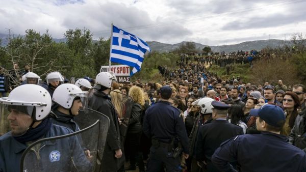 People protest against the so-called "hotspot" being built for refugees and migrants on the Aegean island of Kos, on February 14, 2015. (AFP/Stringer)