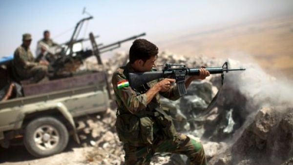 An Iraqi Kurdish Peshmerga fighter fires at Daesh militants during 2014 clashes on the outskirts of Mosul. (AFP/Jean Marc Mojon)