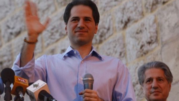 Lebanese MP Samy Gemayel waves to the crowd as his father, former president Amine Gemayel, stands behind him during celebrations by supporters of his party in the mountain resort of Bikfaya on June 8, 2009. (AFP/Joseph Barrak)