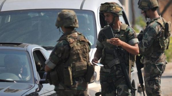 Lebanese soldiers stop vehicles to perform routine checks at a military checkpoint. (AFP/File)