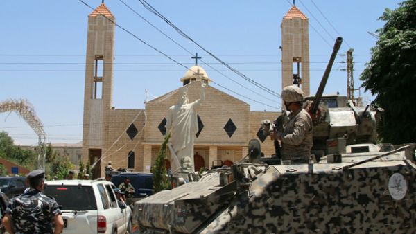 Lebanese soldiers stand guard in front of a church targeted by suicide bombers in al-Qaa. (AFP/Stringer)