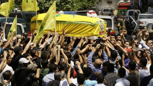 Members and supporters of Lebanon's Shiite Hezbollah movement carry the coffin of their comrade Saleh Ahmad Sabbagh during his funeral in the southern port city of Sidon on May 22 (Mahmoud Zayyat / AFP)