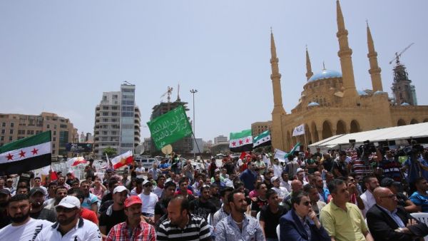 People hold Syrian flags during a protest against the involvement of the Shiite movement Hezbollah in fighting in Syria on June 9, 2013 on the Martys square in the Lebanese capital Beirut (Anwar Amro/ AFP)