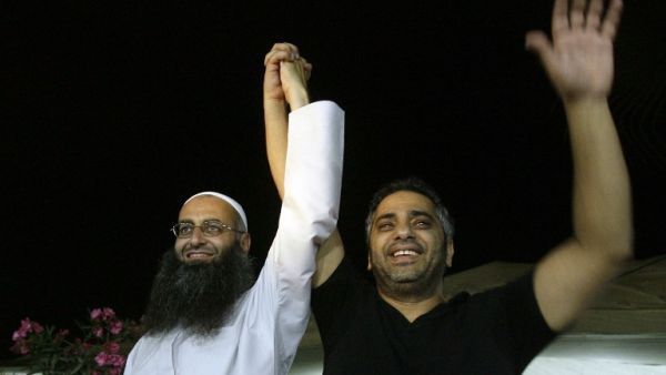 Lebanese Sunni Muslim Salafist cleric Sheikh Ahmed al-Assir (L) holding the hand of Lebanese singer Fadel Shaker during a small concert where he sang Muslim hymns in the southern city of Sidon (Mahmoud Zayyat / AFP)