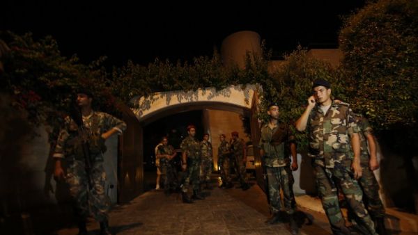 LEBANON, BAABDA : Lebanese army troops secure a private residence where one of two rockets fired from an unknown location exploded in the early hours of August 2, 2013, just metres from an entrance to the presidential palace in Baabda, around eight kilometres southeast of the Lebanese capital Beirut. AFP PHOTO / ANWAR AMRO