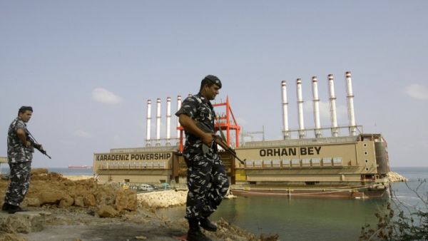 LEBANON, JIYEH : Lebanese police officers guard Turkish local power generating ship Orhan Bey docked in Jiyeh, south of Beirut, on August 13, 2013. AFP PHOTO/MAHMOUD ZAYYAT