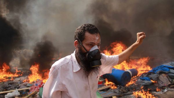 A supporter of the Muslim Brotherhood and Egypt's ousted president Mohamed Morsi gestures during clashes with police in Cairo (AFP/MOSAAB EL-SHAMY)