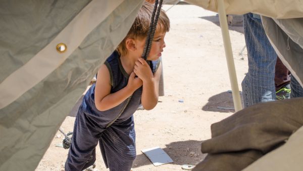A child leans on a rope supporting his new home at Zaatari refugee camp (Albawaba/J. Zach Hollo)