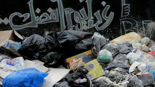 Beirut residents hope that "Tomorrow is a better day" in terms of their waste collection. (AFP/Joseph Eid)