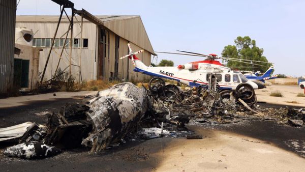A charred airplane lies on the ground at Tripoli international airport in the Libyan capital on July 14, 2014, following fighting between rival armed groups. (Mahmud Turkia/ AFP)