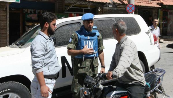 A UN official speaks with locals in the town of Madaya, in Syria, on May 6 2012. (AFP/Louai Beshara)