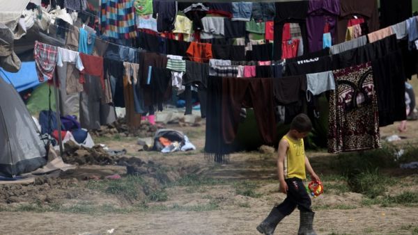 A migrant boy walks at the makeshift camp at the Greek-Macedonian border, near the Greek village of Idomeni on March 30, 2016, where thousands of refugees and migrants are stranded by the Balkan border blockade. (AFP/Sakis Mitrolidis)