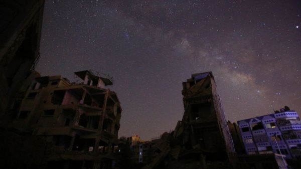 The underground layered graves of war-torn Douma, a Damascus suburb, mirror the bombed-out apartment buildings of the deceased, writes Omar Youssef Souleimane.  (AFP/Sameer al-Doumy)