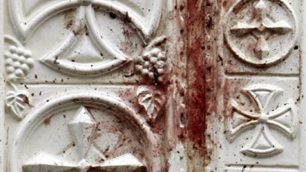 Blood-stains cover the door of the Al-Qiddissine (The Saints) church following an overnight car bomb attack that targeted the church in the Egyptian port city of Alexandria on January 1, 2011 and killed at least 21, hitting Egypt's Christian community, the biggest in the Middle East.