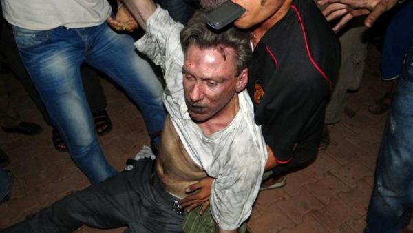 Libyan civilians help an unconscious man, identified by eyewitnesses as US ambassador to Libya, Chris Stevens, at the US consulate compound in Benghazi, following an overnight attack on the building. Stevens and three of his colleagues were killed. (AFP PHOTO/STR)