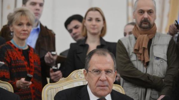 Russia's Foreign Minister Sergei Lavrov is circled by journalists in Moscow on Friday, as he meets his visiting Egypt counterpart Mohamed Amr on the Syrian crisis. (AFP PHOTO / NATALIA KOLESNIKOV)