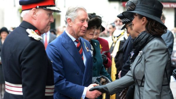 Prince Charles, Prince of Wales, and Camilla, Duchess of Cornwall, shake hands with well-wishers as they leave St John The Baptist City Parish Church in Cardiff. (AFP PHOTO / POOL / ADRIAN SHERRATT)