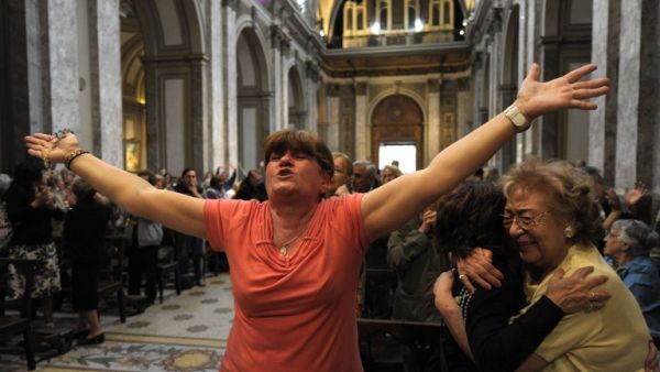 Faithful react after the announcement that Buenos Aires archbishop Jorge Mario Bergoglio was elected Pope Francis I, at Metropolitan Cathedral in Buenos Aires on Wednesday. (AFP PHOTO/JUAN MABROMATA)
