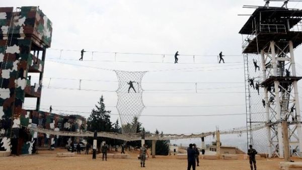 Syrian cadets perform military exercises during their graduation ceremony in Damascus (AFP PHOTO / HO / SANA)