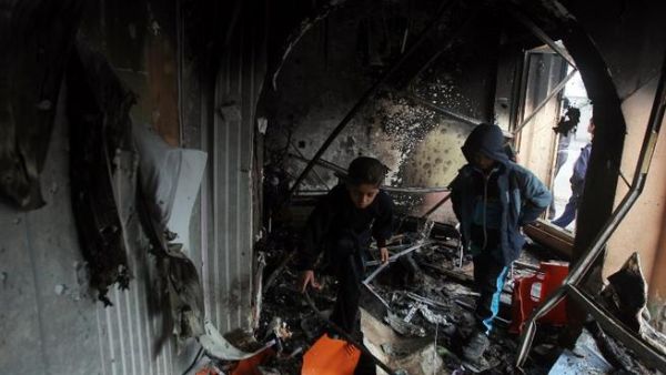 Iraqi children inspect a building in the aftermath of a car bomb in the the mainly Shiite Hurriyah neighbourhood of Baghdad, on Wednesday. (AFP PHOTO / AHMAD AL-RUBAY)
