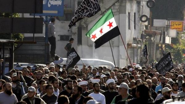 Protestors hold a Syrian pre-Baath flag during a demonstration lead by Lebanese Salafis on Sunday in Southern Lebanon. (AFP PHOTO/MAHMOUD ZAYYAT)