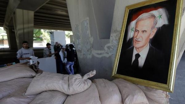 A picture of late Syrian president, Hafez al-Assad, father of current President Bashar al-Assad, seen at an army checkpoint in Damascus. (AFP PHOTO/JOSEPH EID)