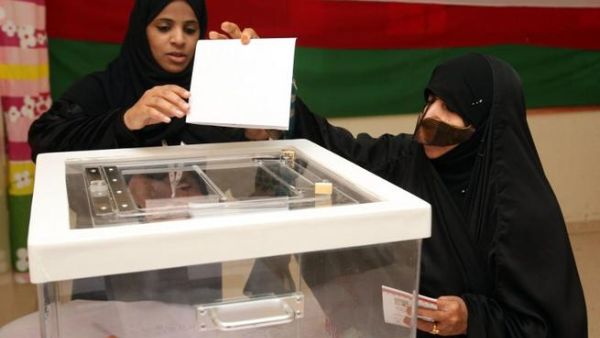 An Omani woman casts her vote at a polling station in the al-Khaburah district, on Saturday. (AFP)