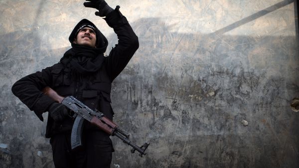 A Rebel fighter points at smoke rising in the city of Aleppo on Friday. UN leader Ban Ki-moon has warned that Syria is in a "death spiral". (AFP)