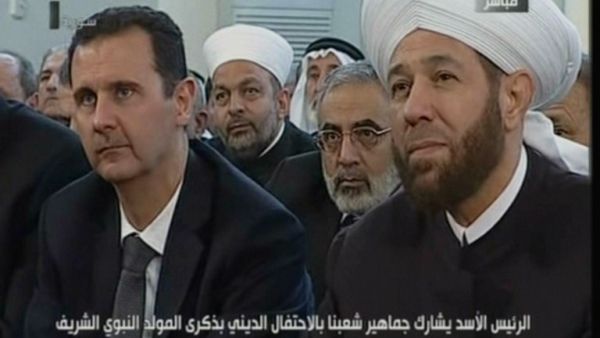 An image grab taken from the state-run Syrian TV shows Syria's President Bashar al-Assad (L) siting next to Syrian Grand Mufti Ahmed Hassun. (AFP PHOTO/SYRIAN TV) 