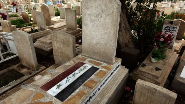 The old Iraqi flag is painted on a tomb of a man killed in 2006 in the Martyrs Cemetery outside the Sunni Abu Hanifa mosque in the Sunni stronghold of Adhamiya. (AFP PHOTO/PATRICK BAZ)