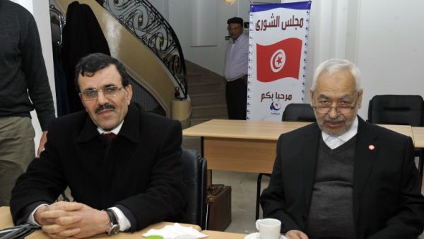 Interior Minister Ali Larayedh and Ennahda ruling party's leader Rached Ghannouchi pose before a meeting at the party's headquarters on Friday. (AFP PHOTO / FETHI BELAID)