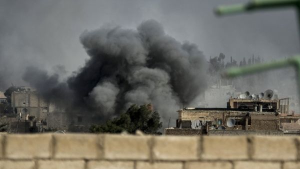 Smoke rises from the site of a missile attack in Hawiqah neighborhood in the eastern Syrian town of Deir Ezzor on Tuesday. (AFP PHOTO/ZAC BAILLIE)